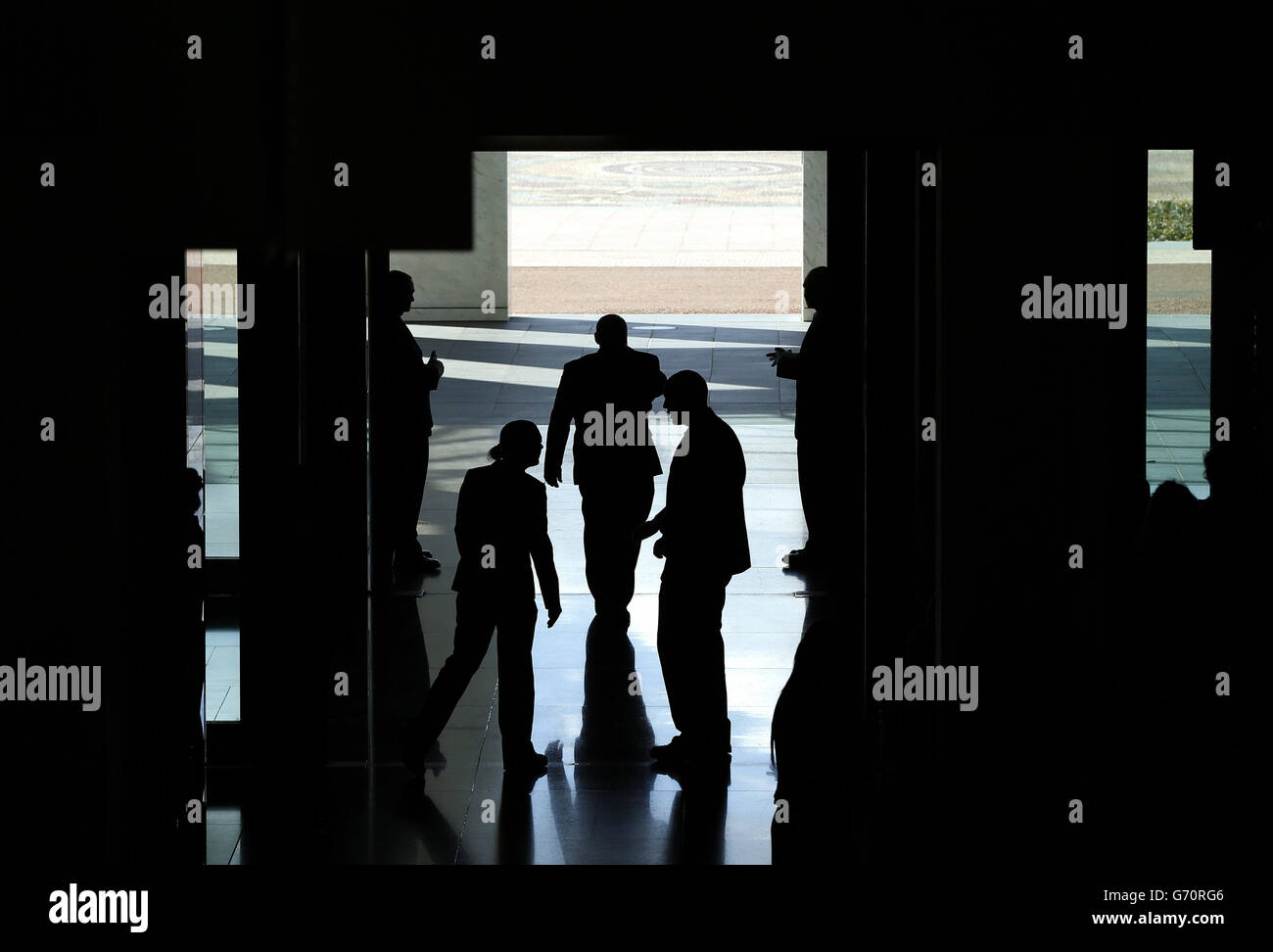 Security staff await the arrival of the Duke and Duchess of Cambridge, at the main entrance to Parliament House in Canberra. The royal couple are on a 19-day official visit to New Zealand and Australia with their son George. Stock Photo