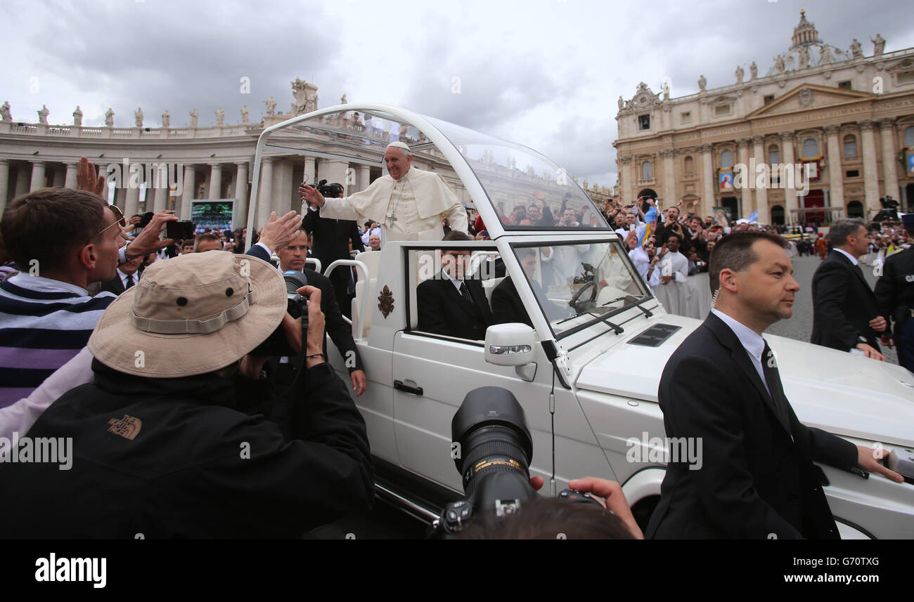 Pope Francis waves to the faithful in St Peter's Square in Rome after the historic canonisation of Popes John XXIII and John Paul II. Stock Photo