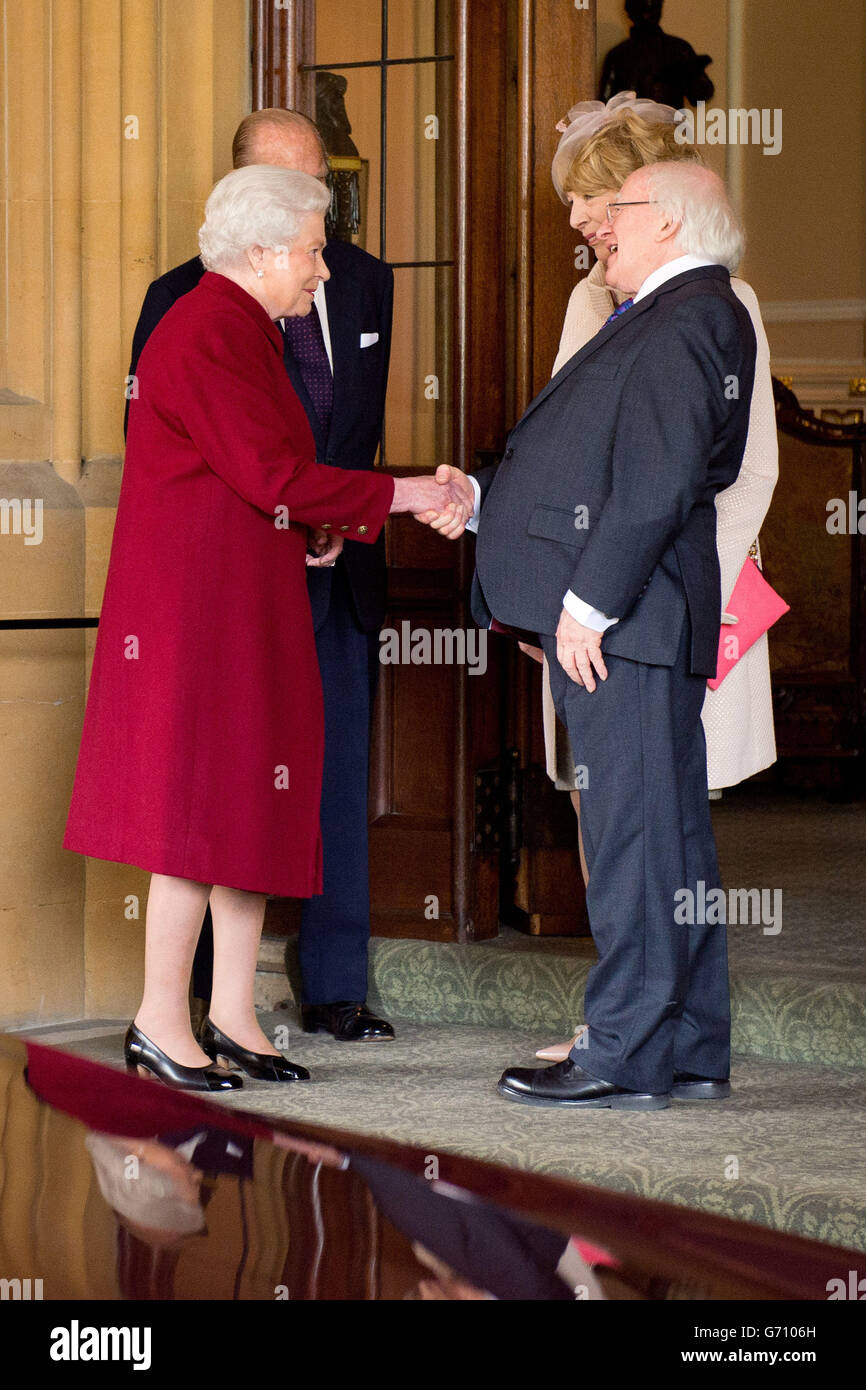 Britain's Queen Elizabeth II (left) and the Duke of Edinburgh, bid farewell to Irish President Michael D. Higgins (right) and his wife Sabina at Windsor Castle in Windsor, after the first State visit to the UK by an Irish President. Stock Photo