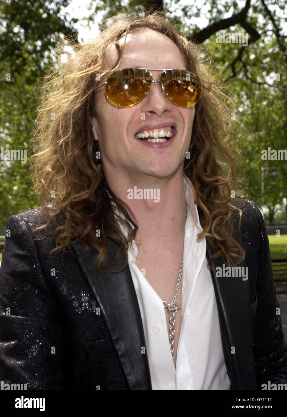 The Darkness frontman Justin Hawkins arrives for the Ivor Novello Awards at the Grosvenor House hotel on Park Lane in central London. The 49th annual awards honour the best songs and film scores of 2003. Stock Photo