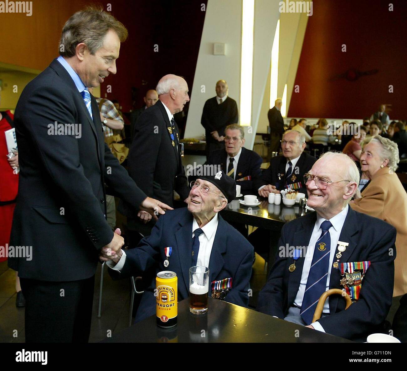 Britain's Prime Minister Tony Blair meets D-Day veteran Bill Ganson, 87, from Northenden, at the Imperial War Museum North in Salford, Greater Manchester. Mr Blair said the visit to the museum, which has launched a programme of events to commemorate the 60th anniversary of the D-Day landing in Normandy, had made him feel emotional and 'inspired'. Stock Photo