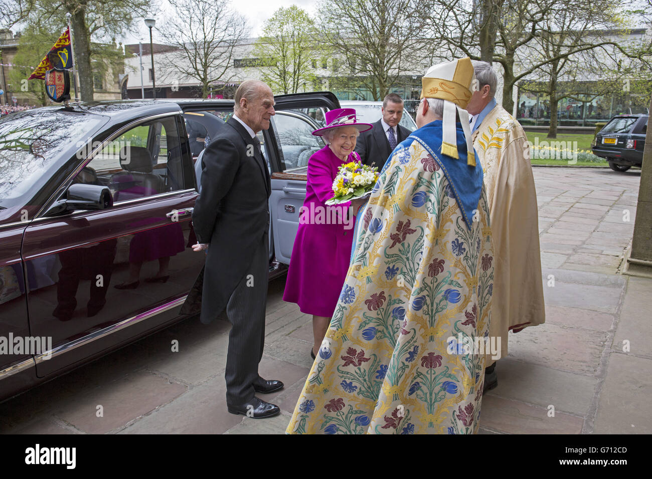 Queen Elizabeth II and the Duke of Edinburgh are greeted by The Very Reverend Christopher Armstrong (Dean of Blackburn) and The Right Reverend Julian Henderson (Bishop of Blackburn) outside Blackburn Cathedral in Lancashire before attending the traditional Royal Maundy Thursday service. Stock Photo