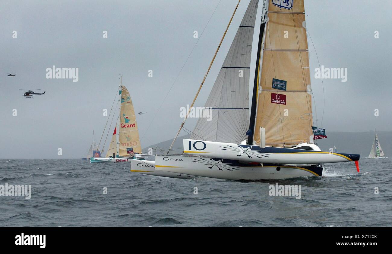 Gitana 10, skippered by Frenchman Marc Guillemot, powers off the start line during the start of the Transat yacht race in Plymouth, The 2,800 mile solo transatlantic race is held every four years and is terminating in Boston, rather than New York, for the first time this year. Stock Photo