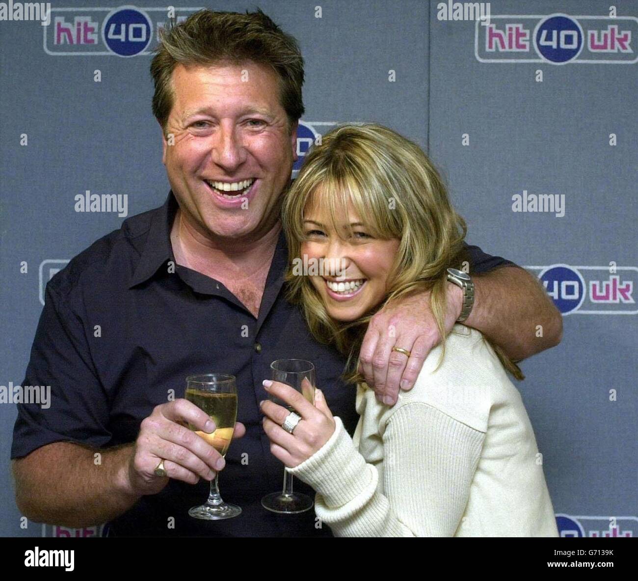 . . Radio DJ Neil Fox celebrates his final Hit40UK show with special guest, singer Rachel Stevens at Capital Radio in Leicester Square, central London. Stock Photo