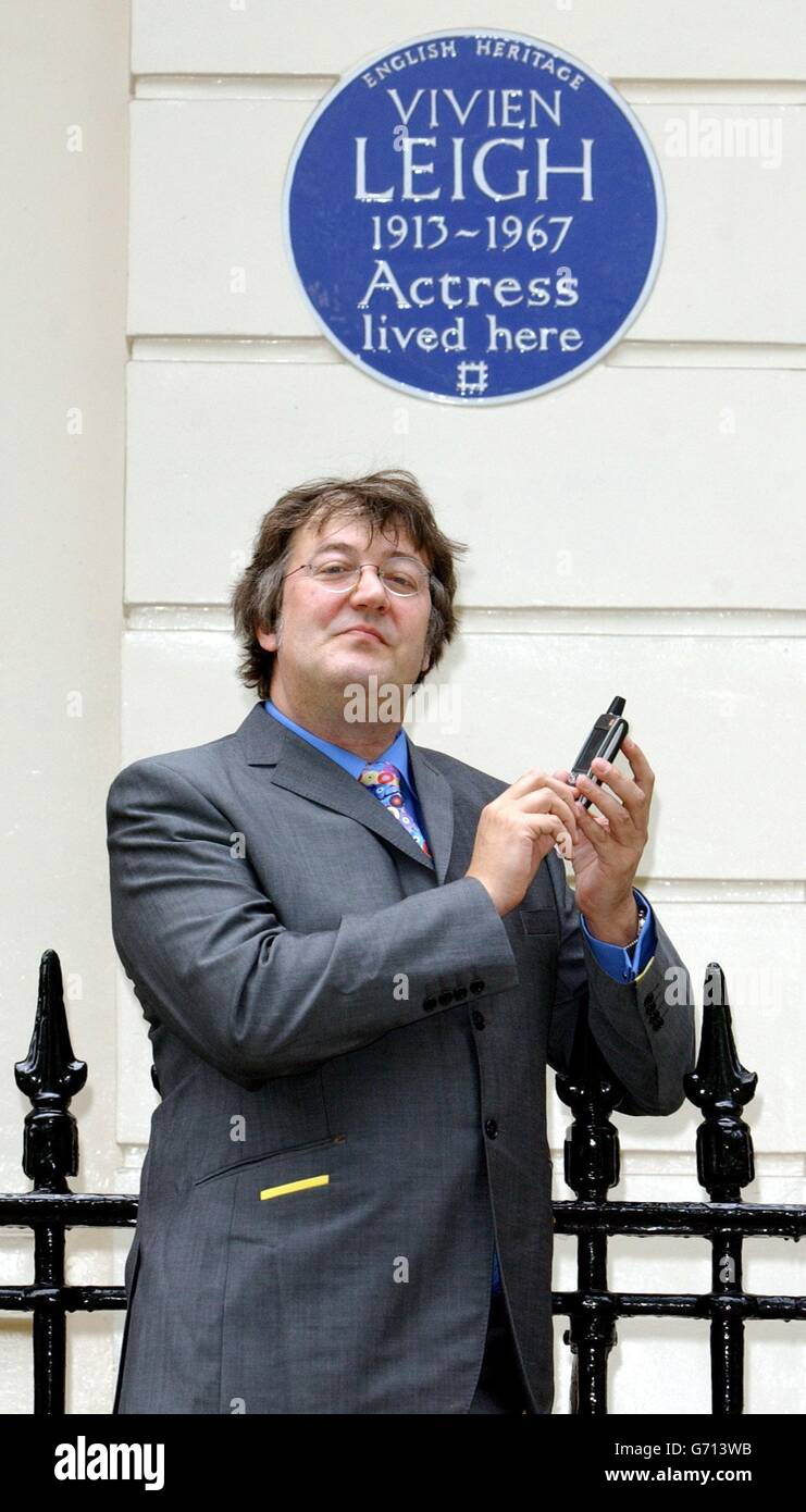 Actor and writer Stephen Fry poses outside 54 Eaton Square in London - the former home of actress Vivien Leigh - during the launch of 'Handheld History' Thursday 3 June 2004. The innovative new guide for mobile phone users links them to the lives of famous figures commemorated with English Heritage Blue Plaques in Central London. PA Photo: Ian West. Stock Photo
