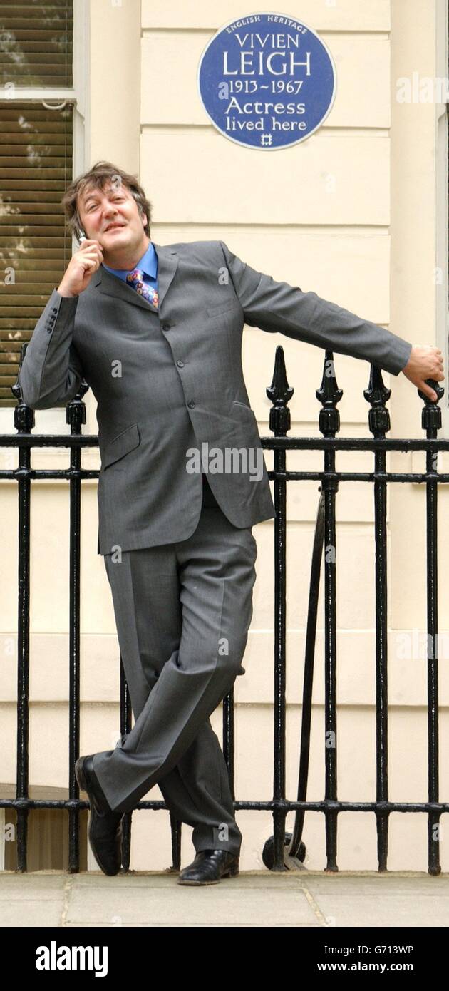 Actor and writer Stephen Fry poses outside 54 Eaton Square in London - the former home of actress Vivien Leigh - during the launch of 'Handheld History' . The innovative new guide for mobile phone users links them to the lives of famous figures commemorated with English Heritage Blue Plaques in Central London. Stock Photo