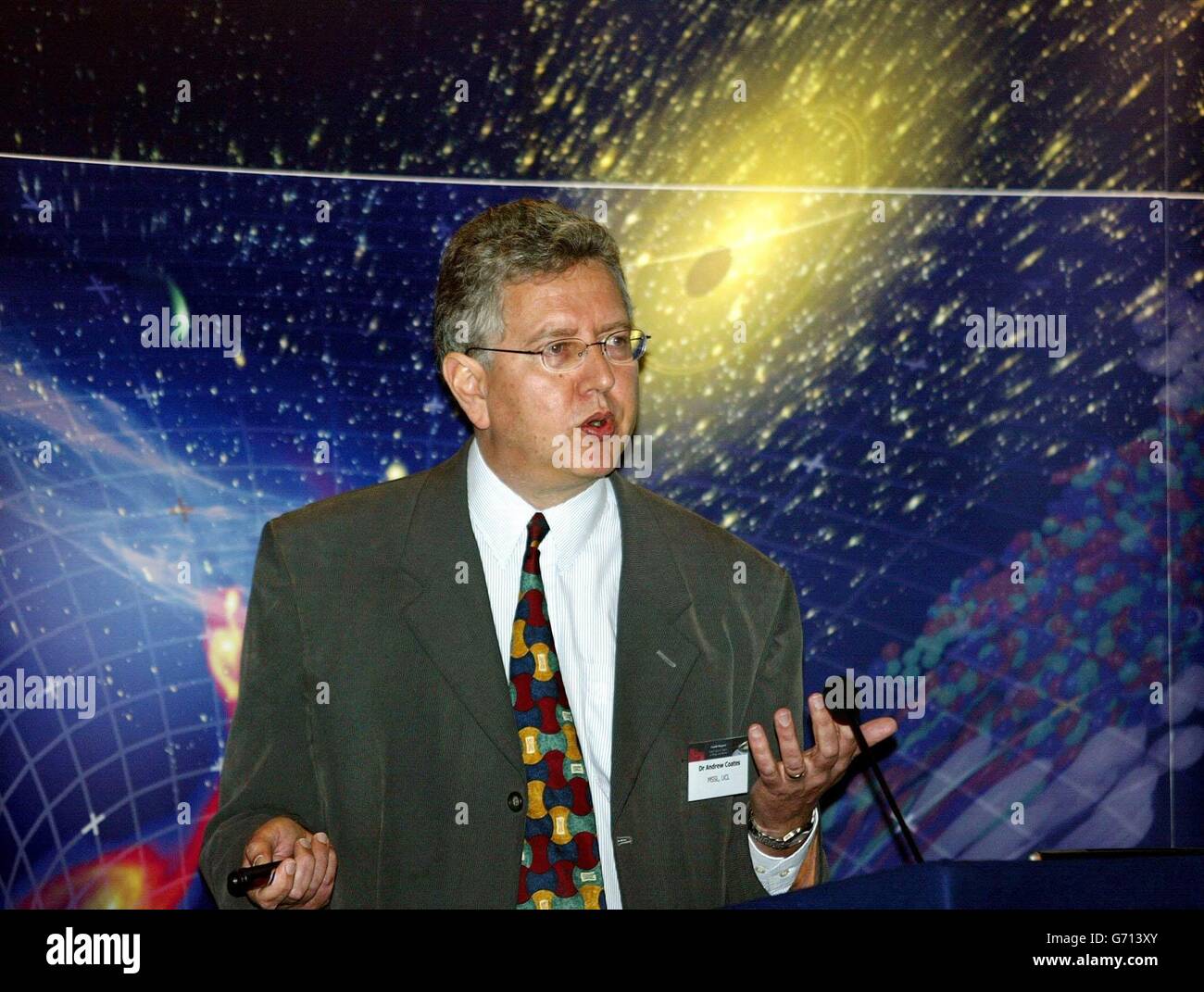 UK scientist Dr. Andrew Coates delivers his speech at the Cassini-Huygens spacecraft press conference at the Connaught Rooms, London. Cassini-Huygens a joint NASA European Space Agency mission will enter Saturn's orbit on July 1, 2004 after a seven year journey. UK scientists are involved with instruments on both the Cassini orbiter and the Huygens probe. Huygens will separate and descend onto Titan, Saturn's largest moon on January 14, 2005. Stock Photo