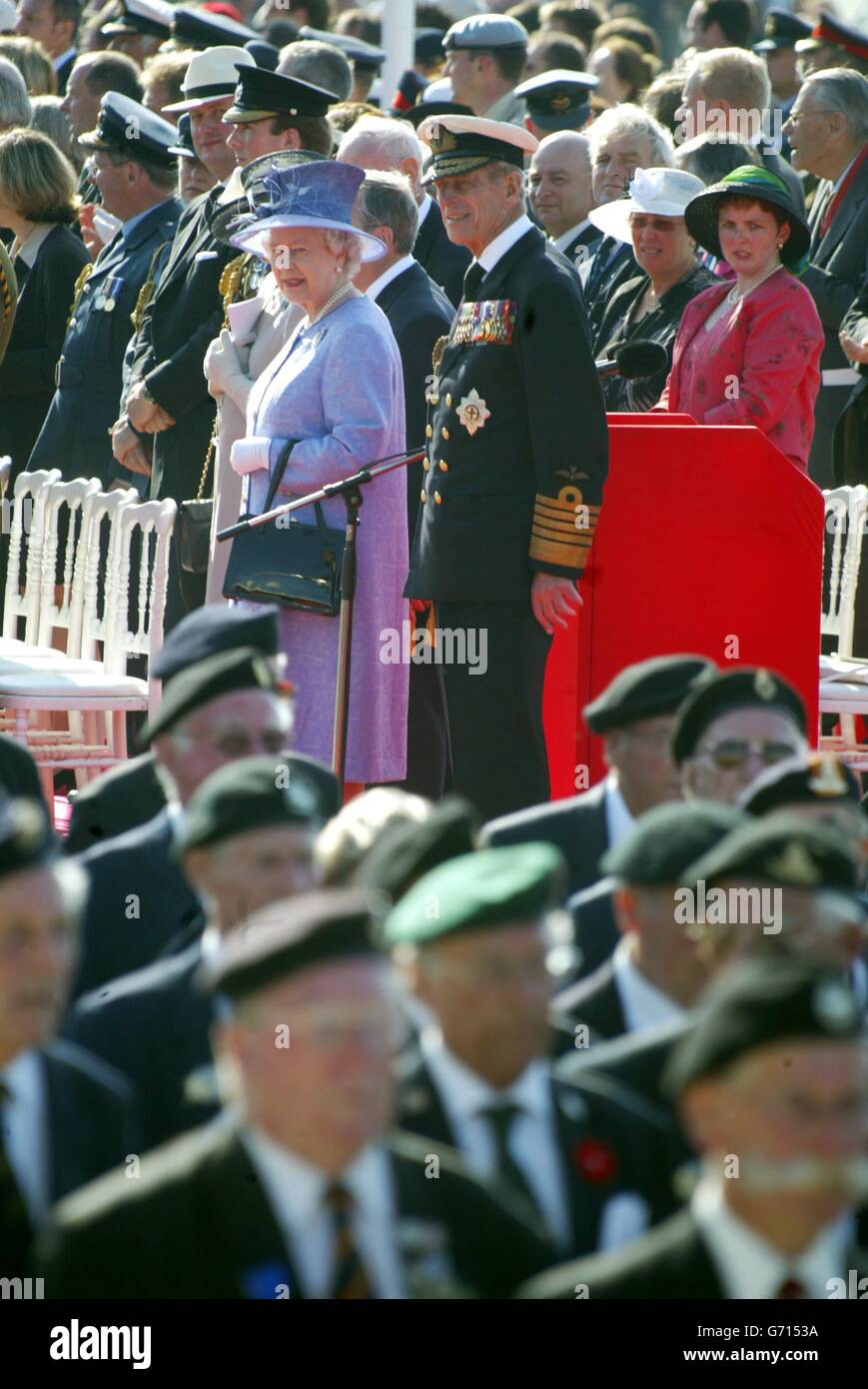 Britain's Queen Elizabeth II watches D-Day veterans march in the Square in Arromanches, France, as part of the 60th Anniversary of the Normandy landings. Stock Photo