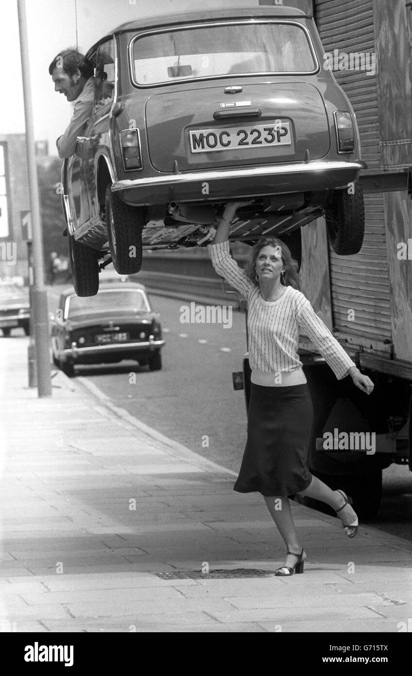 Living up to her super strength image by feigning to lift a Mini suspended above the pavement outside Thames Television's Euston Road studios, is 26-year-old Lindsay Wagner, who is in London to launch her new TV series 'The Bionic Woman'. Stock Photo
