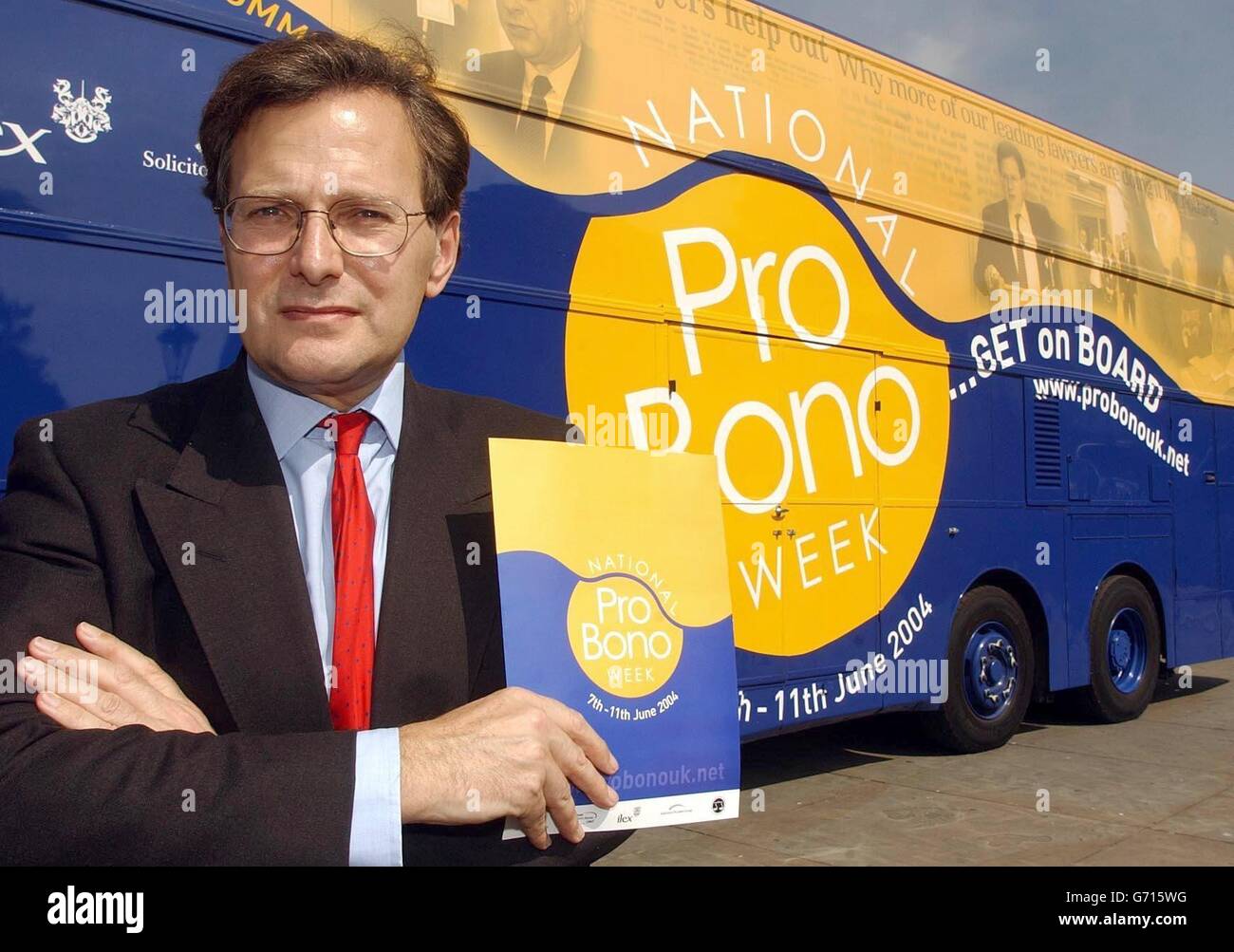 Lord Goldsmith the Attorney General stands in front of the Pro-Bono bus, at the launch of the National Pro-Bono week in Trafalgar Square, Central London. The specially designed double-decker bus will travel around the country, where members of the legal profession will be giving free legal advice to members of the public up and down the country. Stock Photo