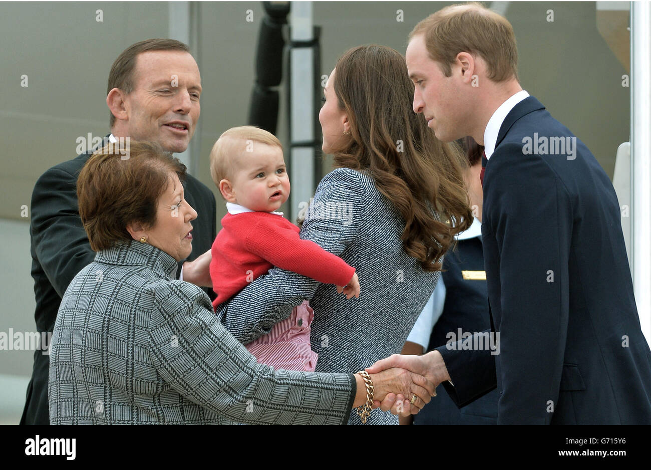Australian Prime Minster Tony Abbott looks-on as the Duke and Duchess of Cambridge and Prince George depart Canberra on the Royal Australian Air Force aircraft to transfer to an international commercial flight to London during the eighteenth day of their official tour to New Zealand and Australia. Stock Photo