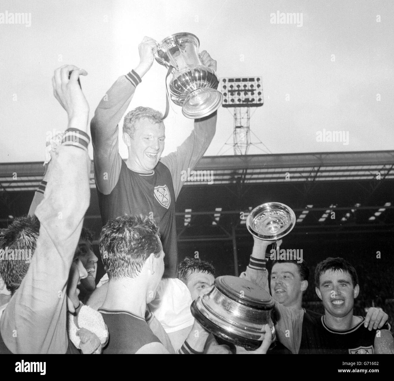 Skipper Bobby Moore and the FA Cup are held aloft in triumph by West Ham United team-mates after the 3-2 victory over Preston North End in the final at Wembley. Stock Photo