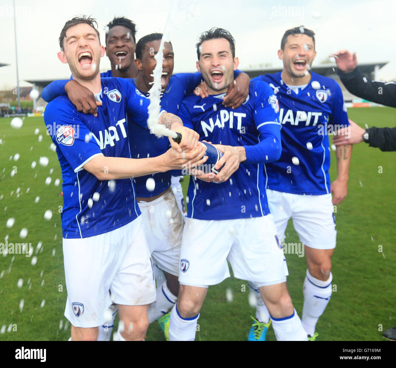 Chesterfield Jay O'Shea (left) sprays champagne as they celebrate promotion during the Sky Bet League Two match at the Pirelli Stadium, Burton Upon Trent. Stock Photo