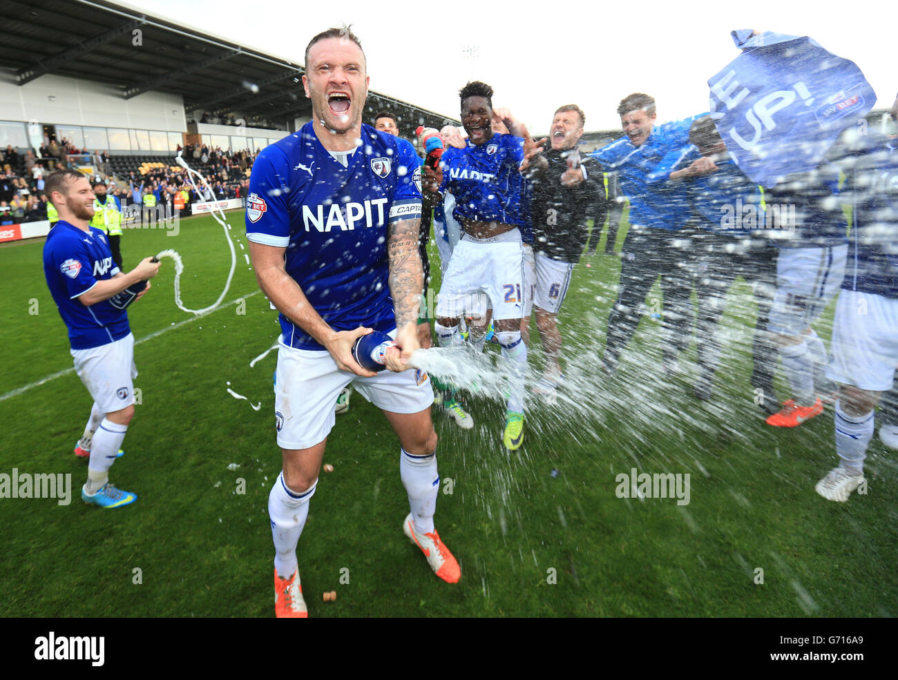 Chesterfield captain ian evatt sprays champagne as they celebrate