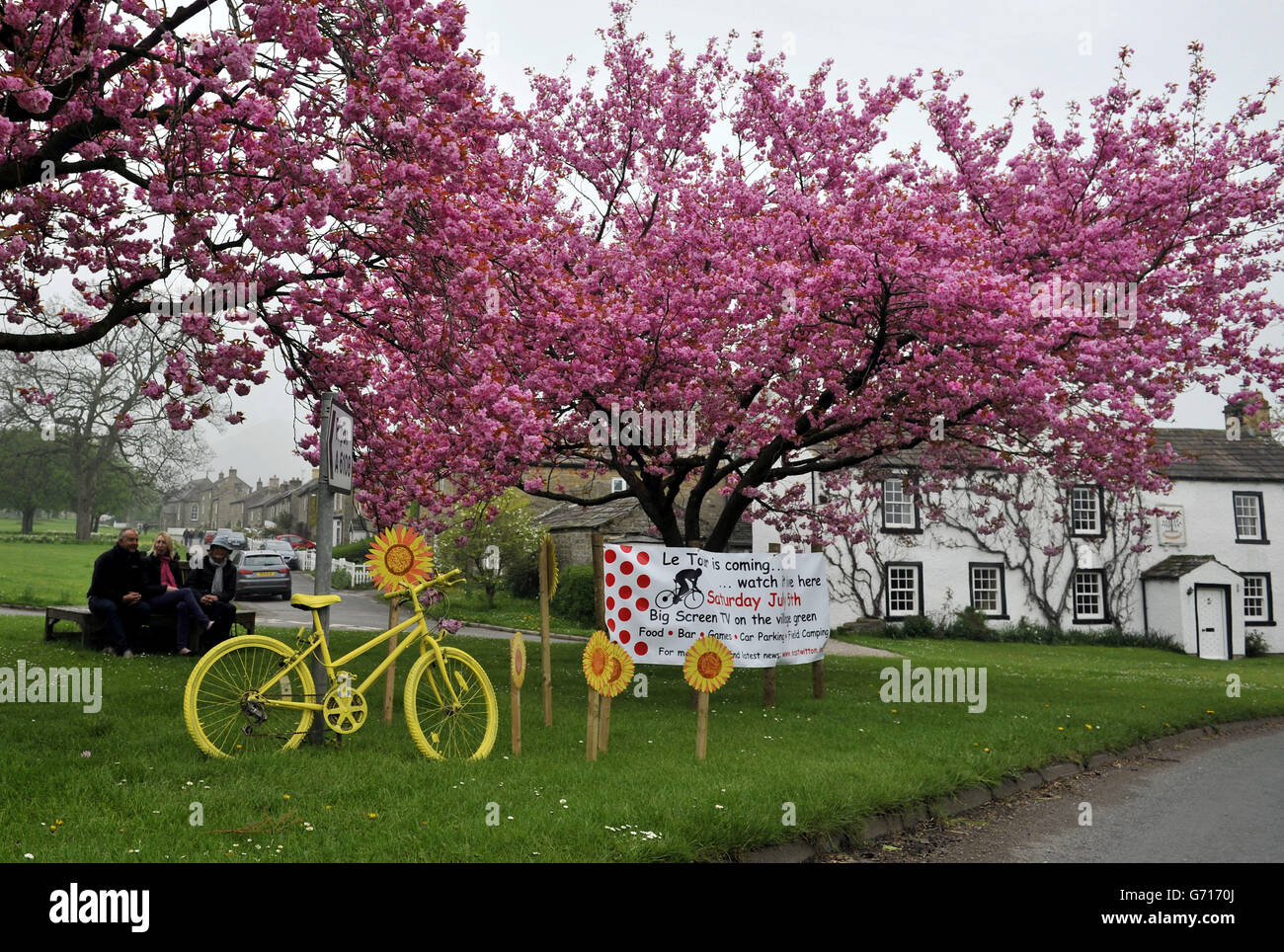 Added colour as the spring blossom at East Witton near Ripon frames a Tour de France display. The big race passes through the dales village on Stage 1 which runs between Leeds and Harrogate. All along the route of the Yorkshire stages TDF themed displays are springing up. Picture Date: Sunday April 27, 2014. Photo Credit Should Read John Giles/PA Stock Photo