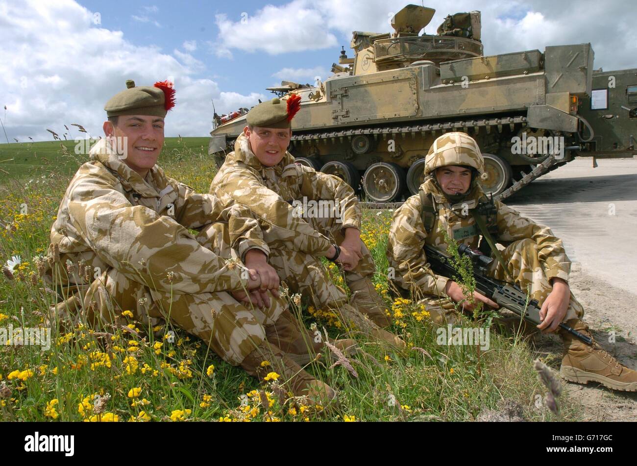 The Lowe family (from left): Paul, Barry and Craig, from Fife, members of the 1st Battalion The Black Watch (Royal Highland Regiment), relax during a training exercise on Salisbury Plain, before the Battallion's deployment to southern Iraq later this month. Paul, 19, and Craig are brothers, and Barry, 22, from Fife, is their cousin. More than 500 soldiers were preparing for their deployment to the region issued with an 'unprecedented amount' of personnel equipment, according to Army chiefs. The Battalion, which played a crucial role in the capture of Basra last year and returned to their base Stock Photo