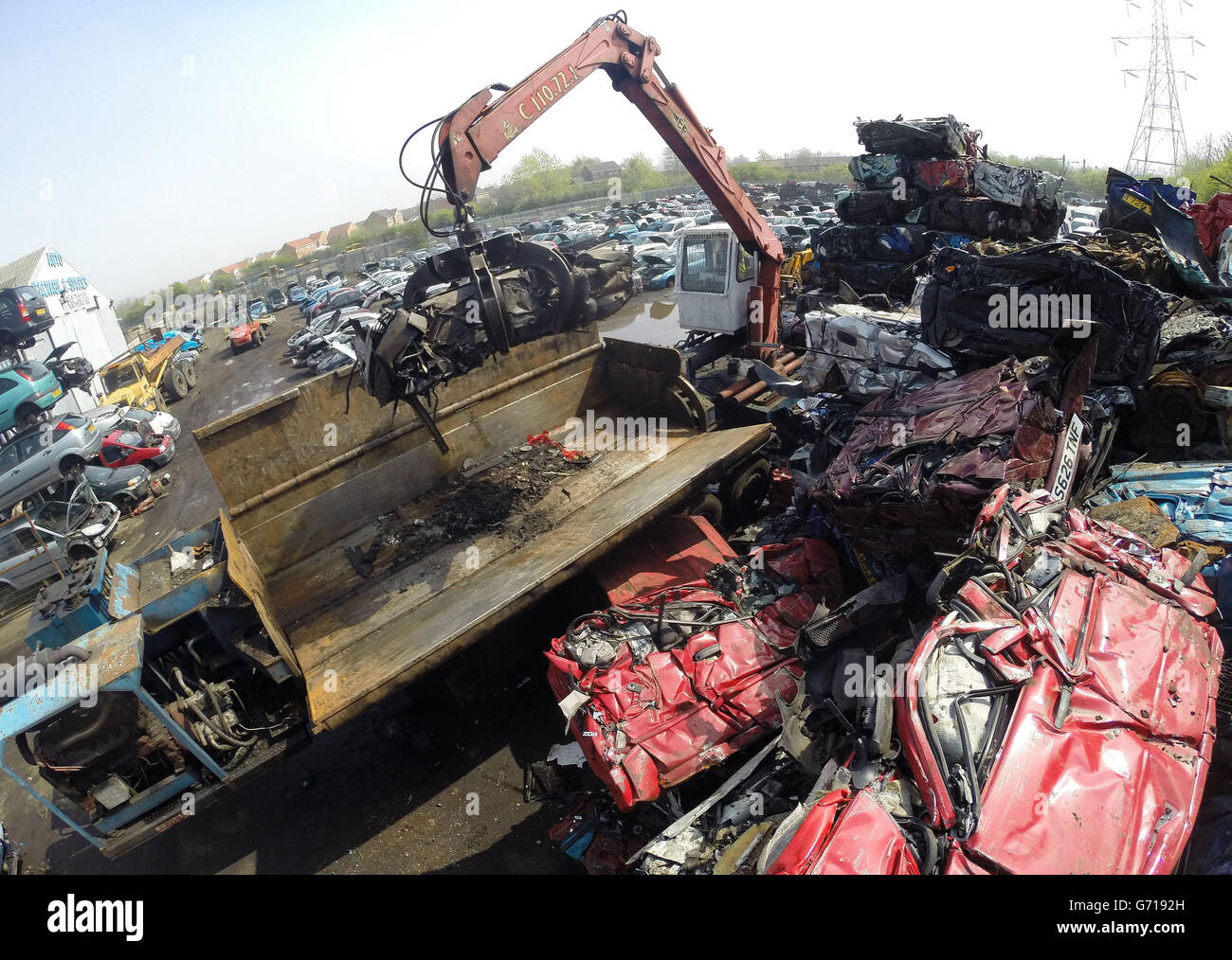 A car is crushed at the UK's largest car dismantlers, Motor Hog in North Shields, Tyneside, which has bought specialist dismantling and de-polluting equipment capable of handling over 200 vehicles per day and crushing hundreds of thousands a year. Stock Photo