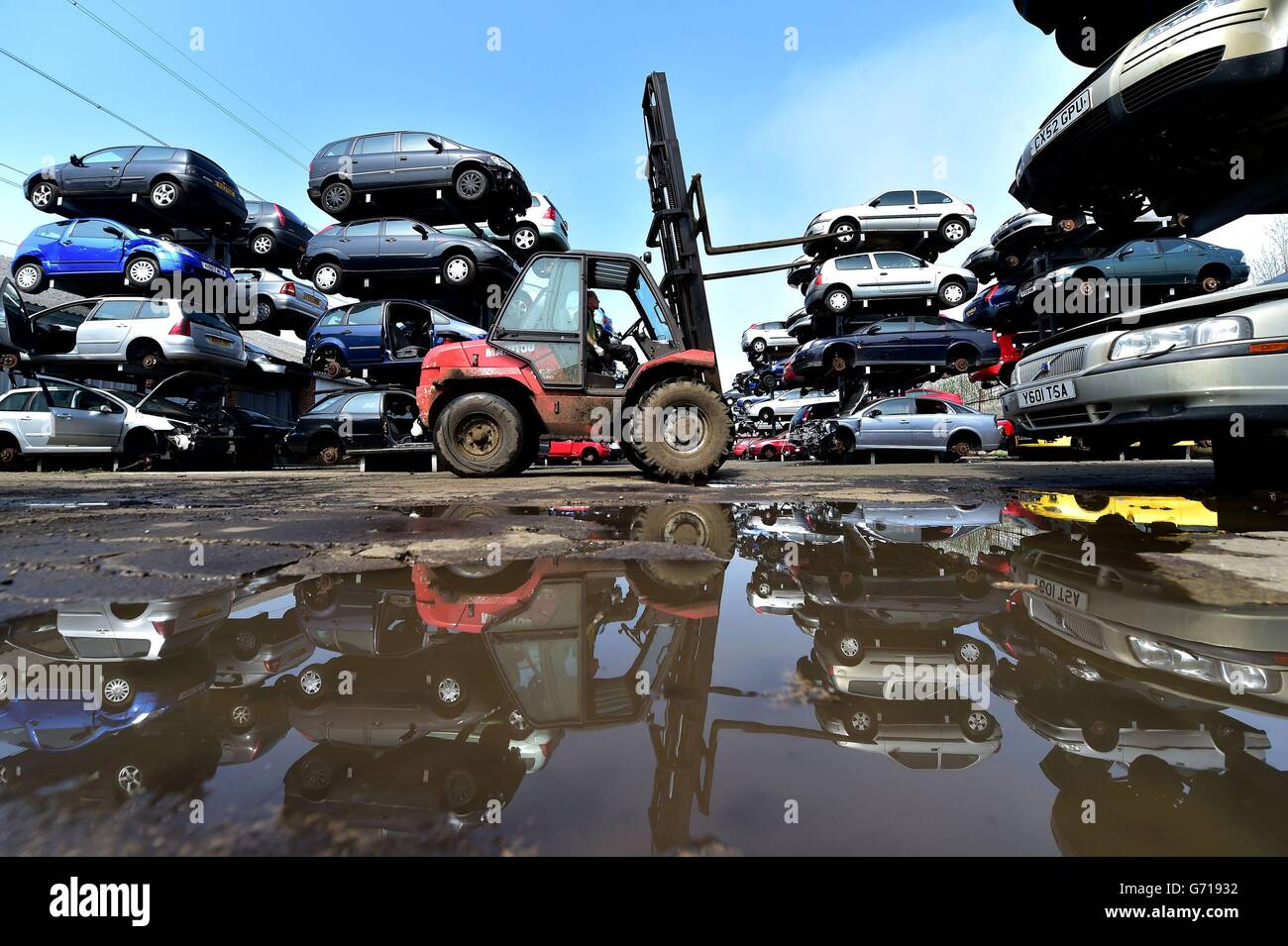 A worker at the UK's largest car dismantlers, Motor Hog in North Shields, Tyneside, which has bought specialist dismantling and de-polluting equipment capable of handling over 200 vehicles per day and crushing hundreds of thousands a year. Stock Photo