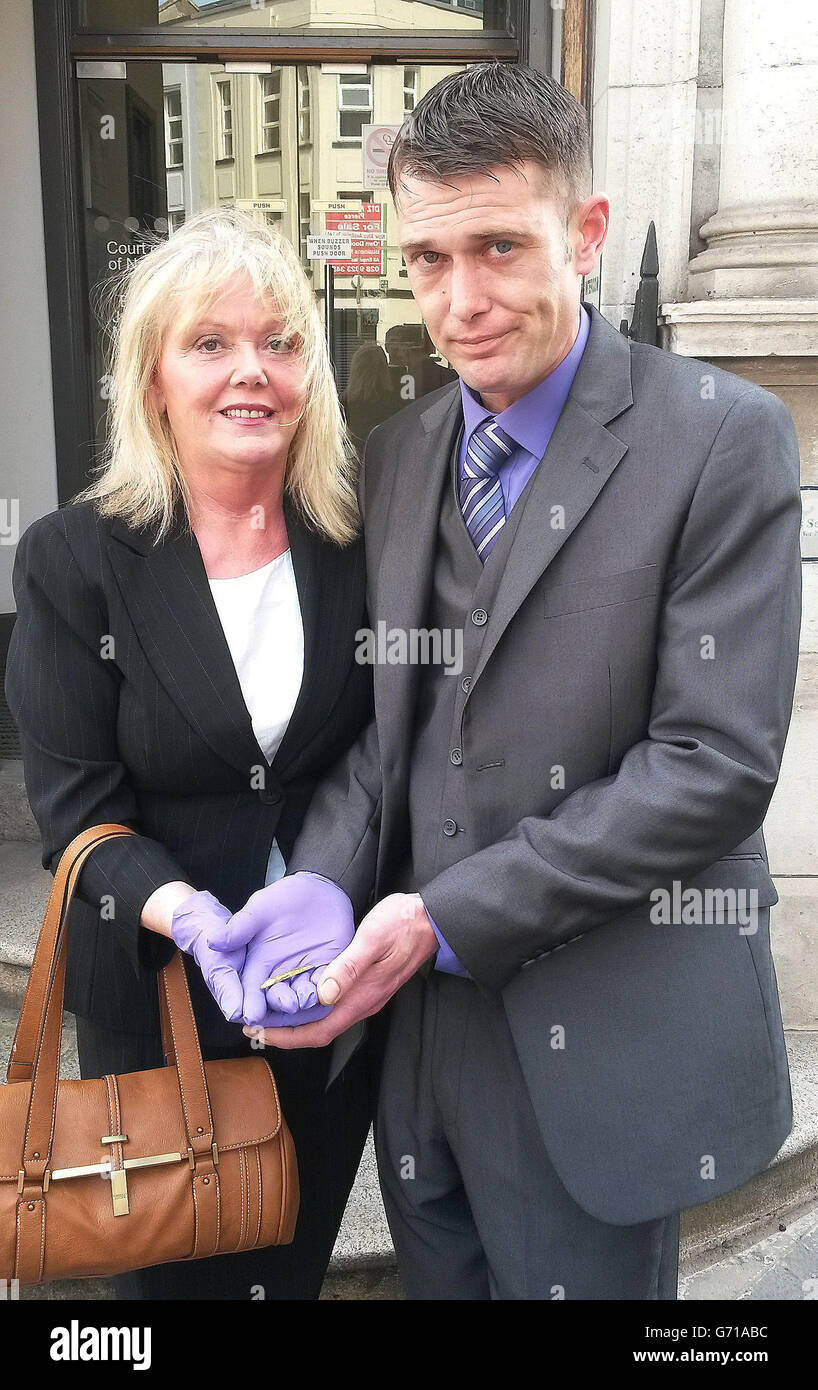 Barry Shannon with his aunt Jean McKee holding a rare golden fish, that experts believe is part of an ornate belt buckle, that was discovered by Barry whilst metal detecting on his aunt's farm in Ballyalton near Downpatrick last year, following a treasure inquest that declared the item to be treasure at the Belfast Coroner's Court. Stock Photo