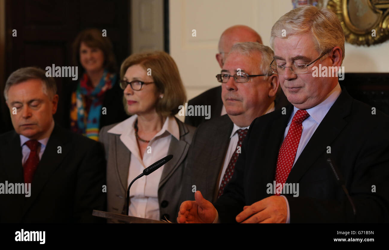 Ireland's deputy prime minister Eamon Gilmore (right), the Labour Party chief and Foreign Affairs Minister in the Republic's coalition government announces his resignation as the leader of the Labour party in front of his ministerial colleagues at the department of Foreign Affairs in Dublin. Stock Photo