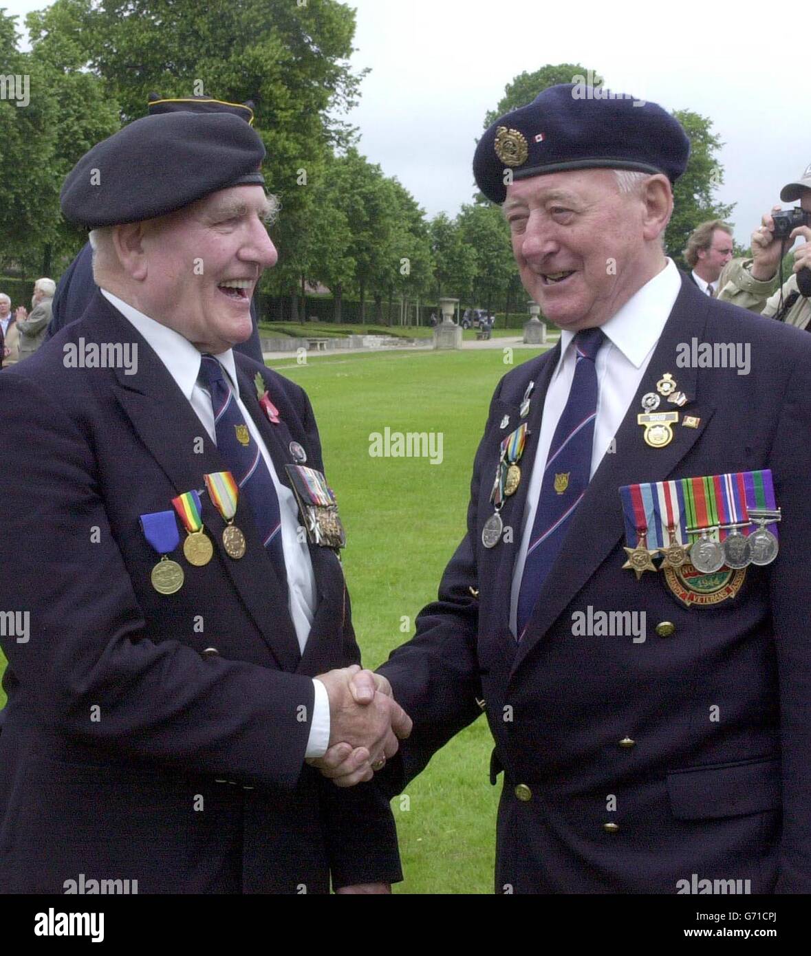 D-Day veterans Royal Engineer Jack Summers, from North Hykeham, Lincs, and, right, Durham Light Infantryman George Richardson, from Calverton, Notts, reminisce at a ceremony in Caen, to award Normandy 60th anniversary badges to veterans of the campaign. Stock Photo