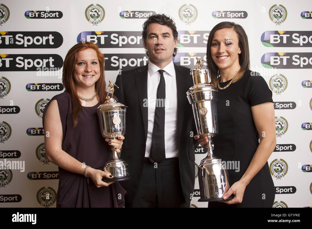 Liverpool Ladies Lucy Bronze (right) with the PFA Player Of The Year Award and Liverpool Ladies Martha Harris (left) with the PFA Young Player Of The Year Award, alongside BT Group Chief Executive Gavin Patterson, during the PFA Player of the Year Awards at the Grosvenor Hotel, London. Stock Photo