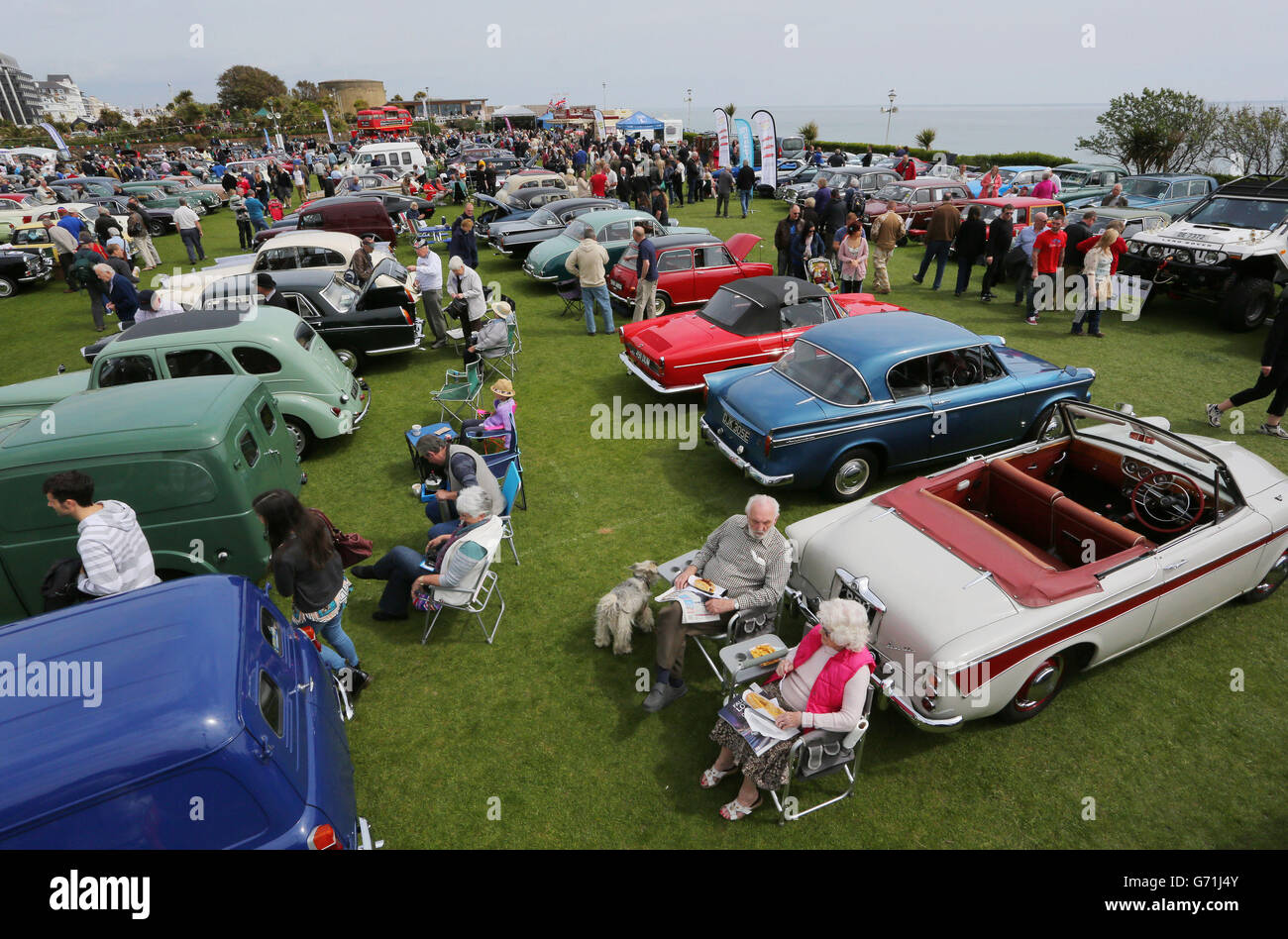 A couple enjoy the fine weather at the back of their classic car in Eastbourne, Sussex, during the second day of Magnificent Motors, as around 600 vintage and classic vehicles take part in the largest free motoring spectacular on the south coast. Stock Photo
