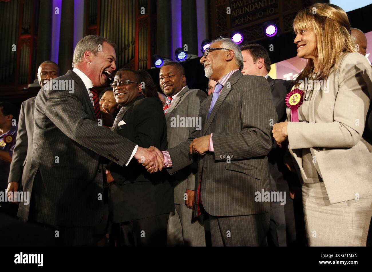 Nigel Farage (left) arrives on stage during a Ukip rally held at the ...