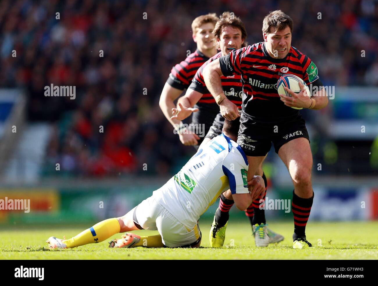Saracens Schalk Brits is tackled by Clermont's Mike Delany during the Heineken Cup Semi Final match at Twickenham, London. Stock Photo