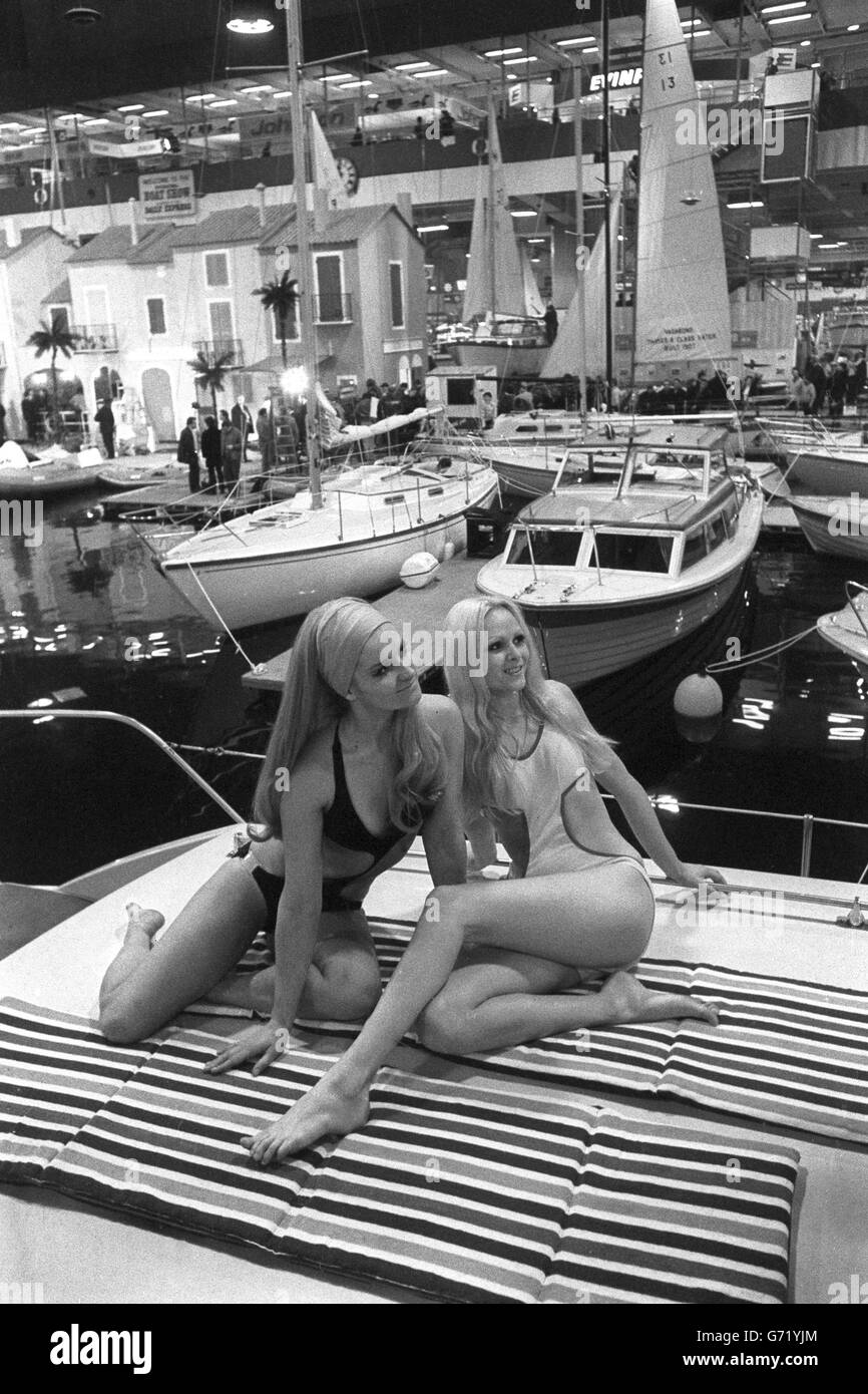 Models Lena Ellis (l) and Cherokee Burton in their swim suits onboard a craft during today's preview of the International Boat Show opening at Earls Court, London. Stock Photo