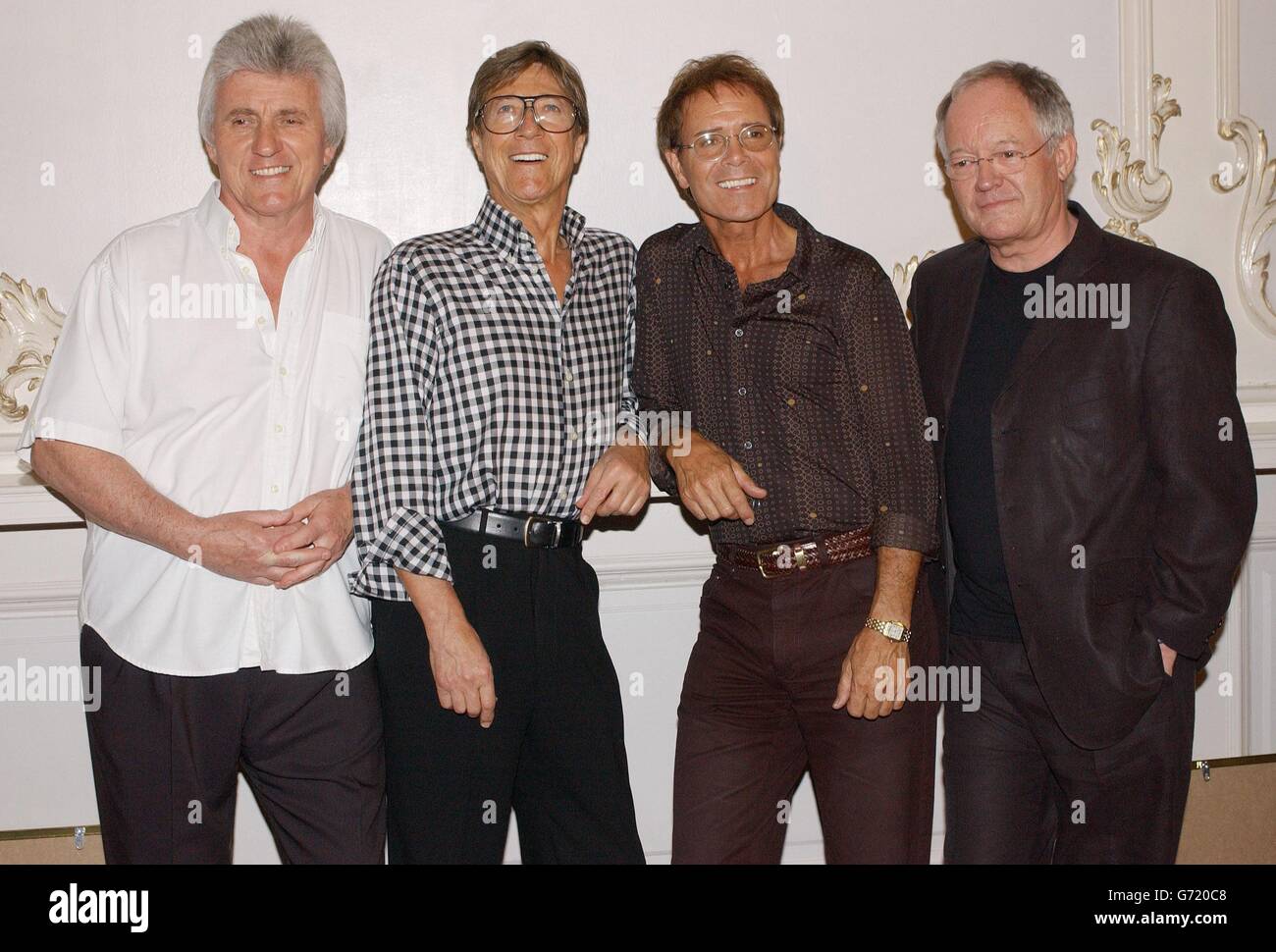 Sir Cliff Richard (second right) with the Shadows, (from left) Bruce Welch, Hank B Marvin and Brian Bennett at the London Palladium, ahead of their final concert appearance together, which will see Sir Cliff sing three numbers. Band members Marvin, Bruce Welch and Brian Bennett have been touring the UK for the last time in their 45-year career, playing 37 sellout dates before their last ever performance. The group are holding gold discs to mark more than 100,000 sales of their recent double CD Life Story - The Very Best Of The Shadows. Stock Photo