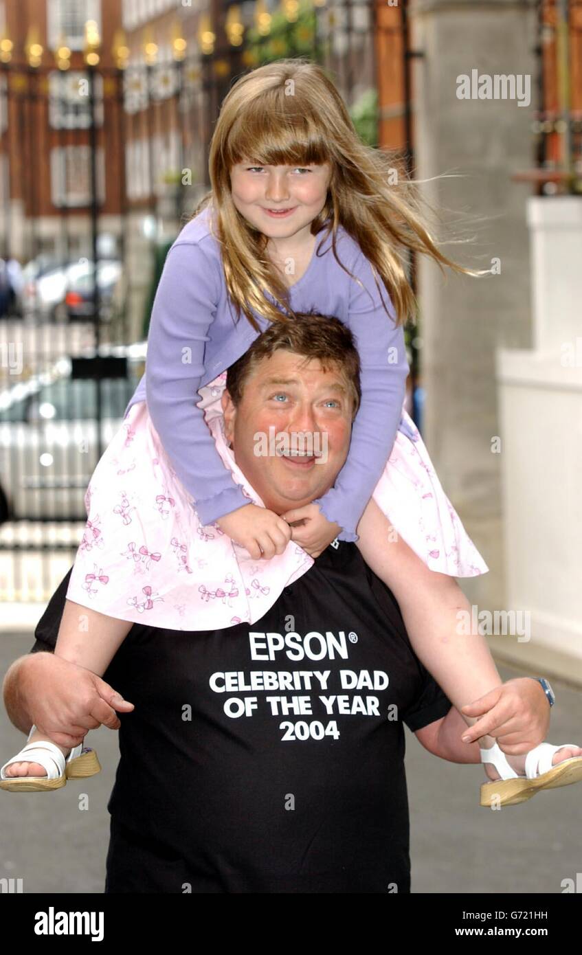 Heart FM DJ's Jono Coleman with his daughter Emily, 7, during a photocall to celebrate winning the Epsom Celebrity Dad of the Year 2004 jointly with Ground Force presenter Tommy Walsh, outside the Grovesnor House Hotel in central London. Stock Photo