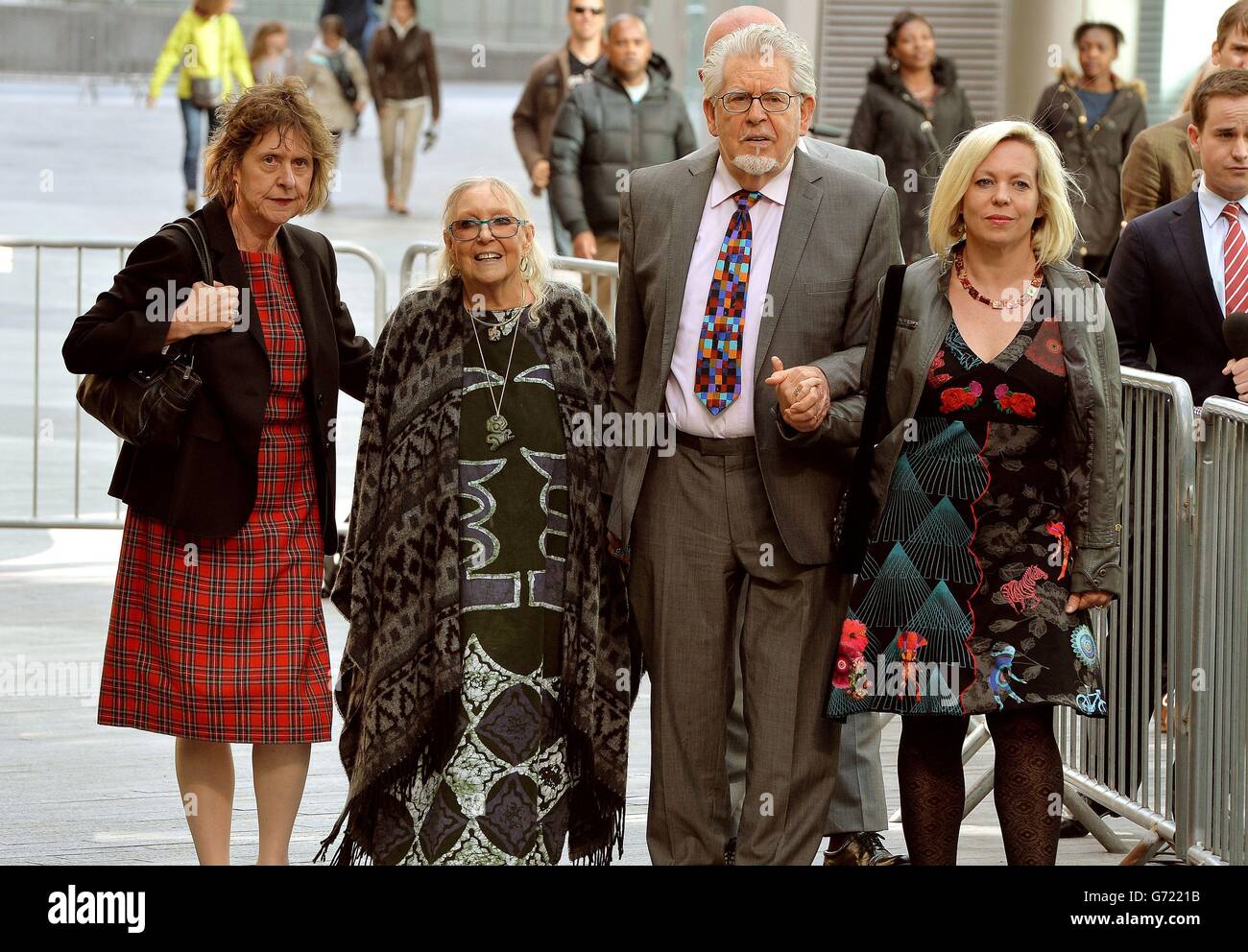 Veteran entertainer Rolf Harris hand in hand with his wife Alwen, daughter Bindi and niece Jenny (left),leave Southwark Crown Court, London after the first day of his trial where he denies 12 counts of indecent assault between 1968 and 1986. Stock Photo