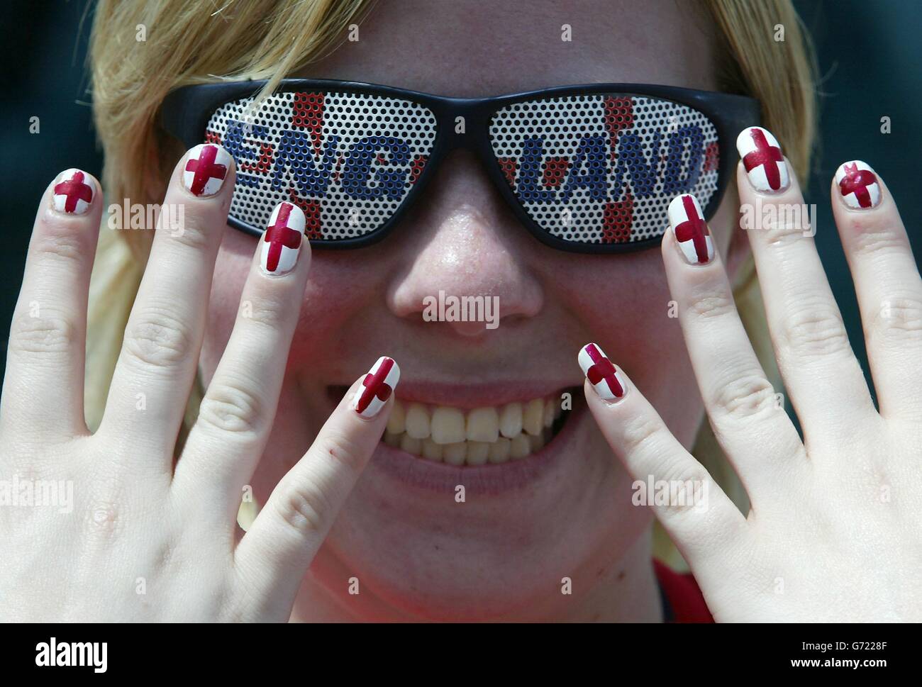 England fan Vanessa Ginilli from Milton Keynes shows her patriotism in Rossio Square, Lisbon before England and Croatia meet in the Euro 2004 championship at the Estadio Da Luz. Stock Photo