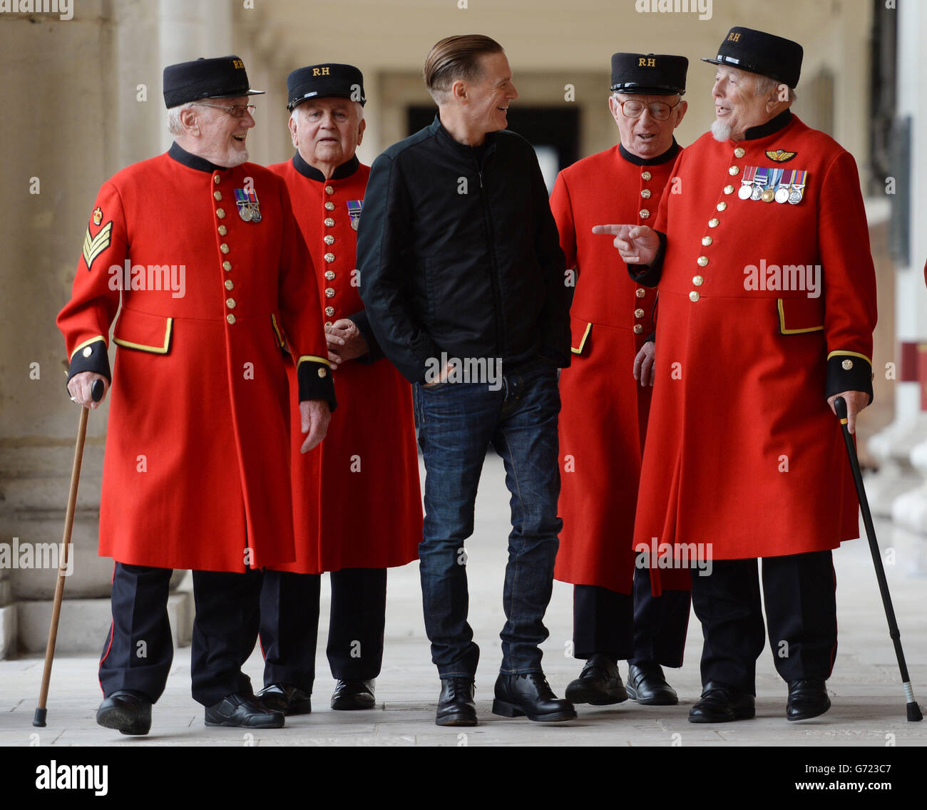 Singer and photographer Bryan Adams meets Chelsea Pensioners at the Royal Chelsea Hospital in London, where he unveiled a berth named in honour of the Bryan Adams Foundation, which has supported the hospital's extensive refurbishment. Stock Photo
