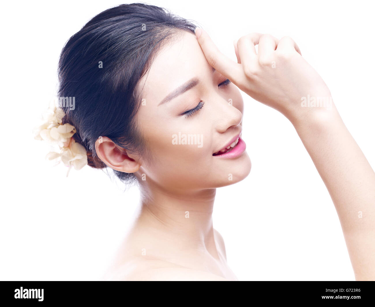 studio portrait of a young asian woman, eyes closed, side view, isolated on white. Stock Photo