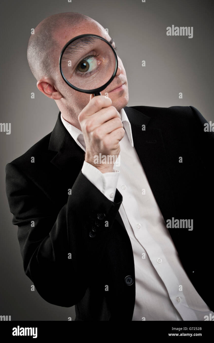 Businessman with magnifying glass Stock Photo
