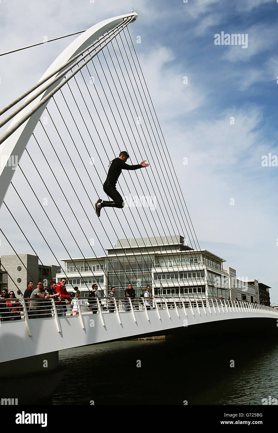People jump from the Samuel Beckett Bridge into the River Liffey, Dublin, during a period of warm weather. PRESS ASSOCIATION Photo. Picture date: Saturday May 17, 2014. Photo credit should read: Brian Lawless/PA Wire Stock Photo