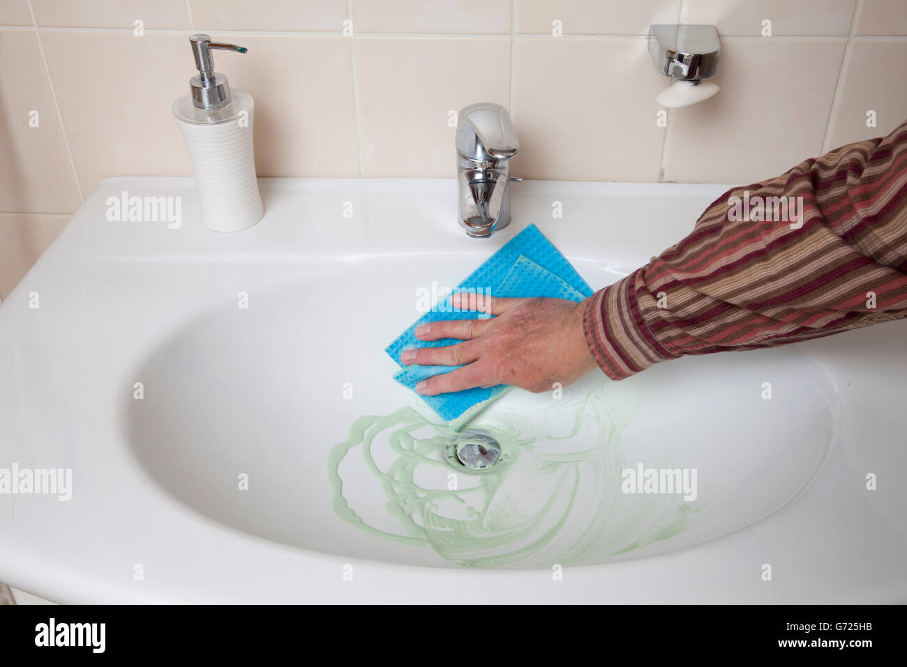 Man cleaning sink Stock Photo
