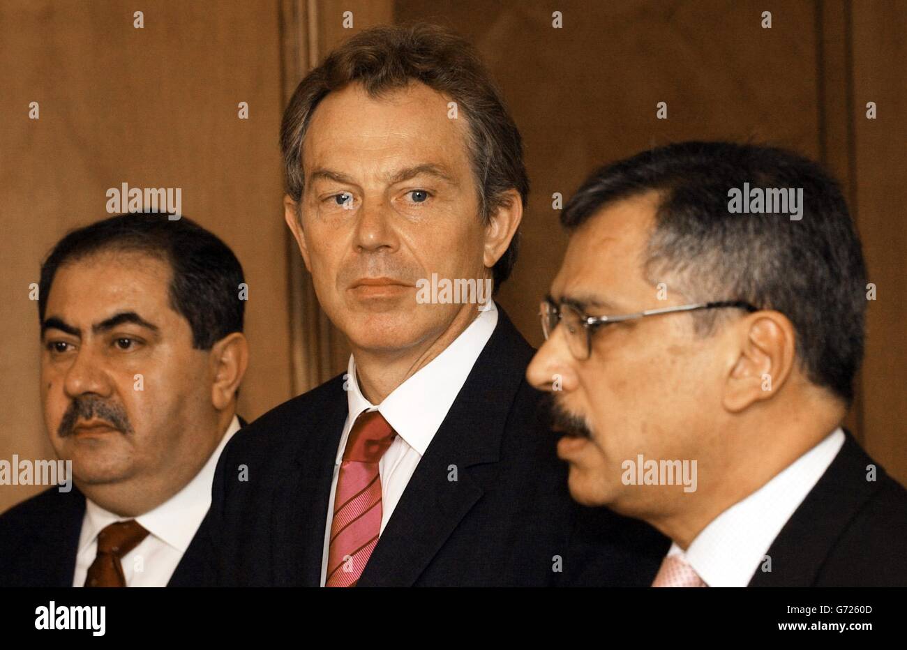 Prime Minister Tony Blair (centre) holds a news conference with Iraqi Foreign Minister Hoshyar Zebari (left) and Iraqi Defence Minister Hazim al - Shalan after holding talks with them at the NATO Summit in Istanbul. The US-led coalition has transferred sovereignty to an interim Iraqi government in Baghdad , speeding up the move by two days in an apparent bid to surprise insurgents who may have tried to sabotage the step toward self rule. Stock Photo