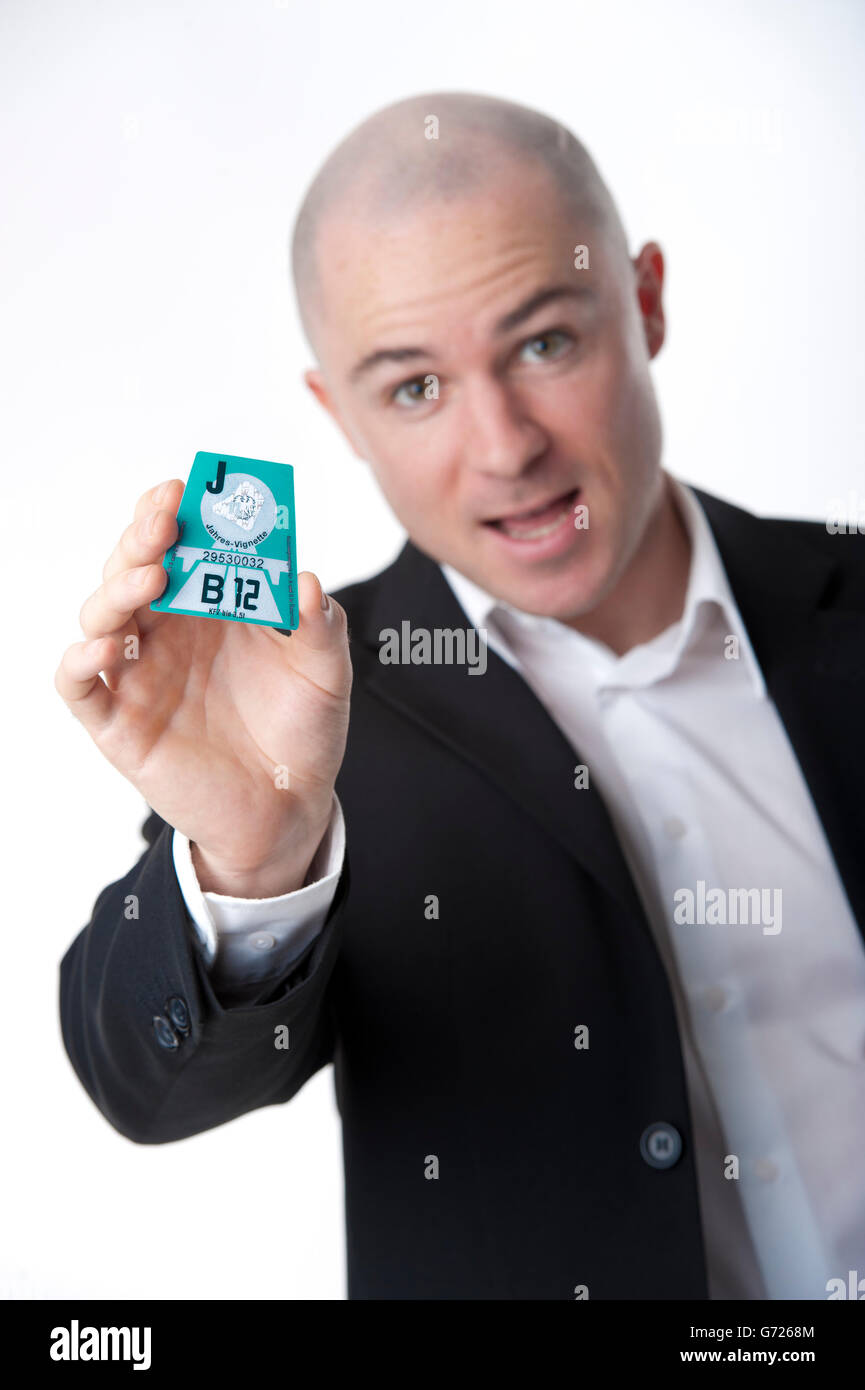 Man presenting Austrian road tax vignette 2012 Stock Photo - Alamy