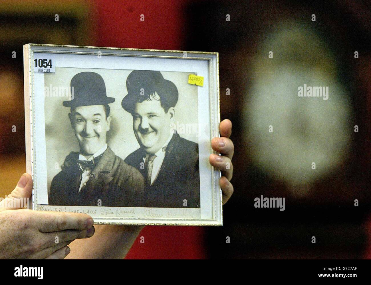 A collection of rare and unsean pictures of Stan Laurel family Memorabilla went under the hammer at Anderson and Garland in Newcastle where there pictures totalled over 20,000. The picture shown here is a framed picture of Stan Laurel and Oliver Hardy, signed by Oliver Hardy 'To Huntley ! Love - Uncle Stan Laurel'. Stock Photo
