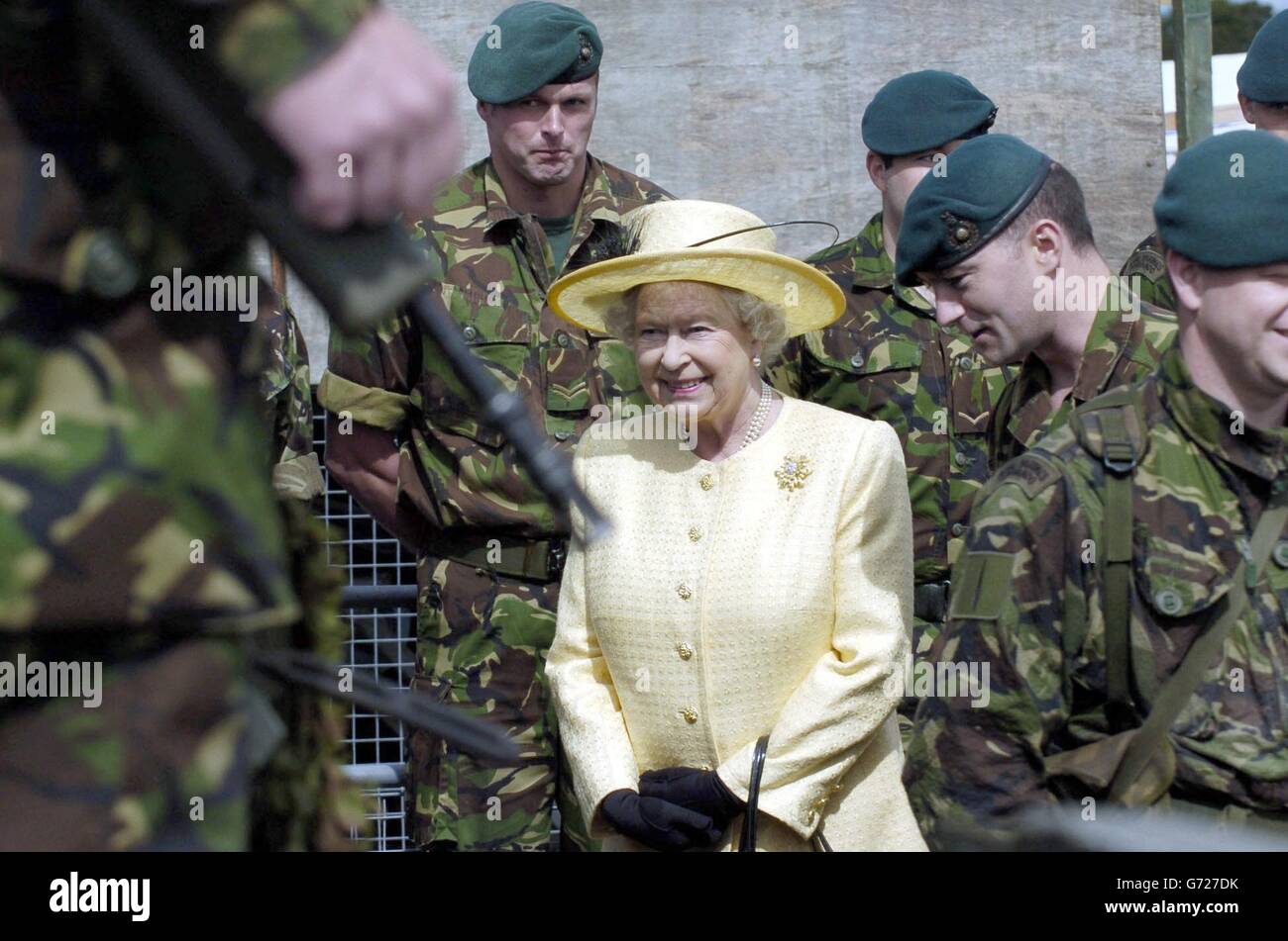 Her Majesty the Queen accompanied Lt. Col. Tim Bevis (commanding officer of 45 Commando Unit (second right) views equipment used by 45 Commando unit whilst visiting Royal Marines Condor Base in Arbroath. Stock Photo
