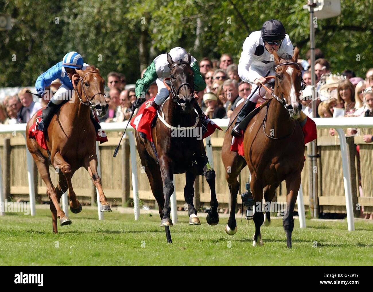 Soviet Song ridden by jockey Johnny Murtagh (right) leads home second placed Attraction ridden by Kevin Darley and third placed Baqah ridden by Davy Bonilla (left) in the 2.55 at Newmarket. Stock Photo