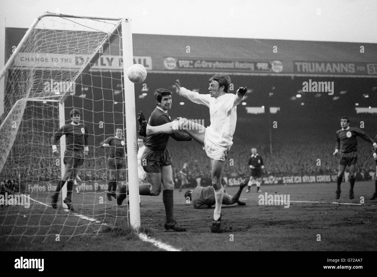 West Bromwich Albion forward Clive Clark tries to score from a corner as Liverpool goalkeeper Tommy Lawrence lies beaten to the ball behind him during the second replay of the sixth round FA Cup tie at Maine Road, Manchester. West Bromwich won the match 2-1. Stock Photo