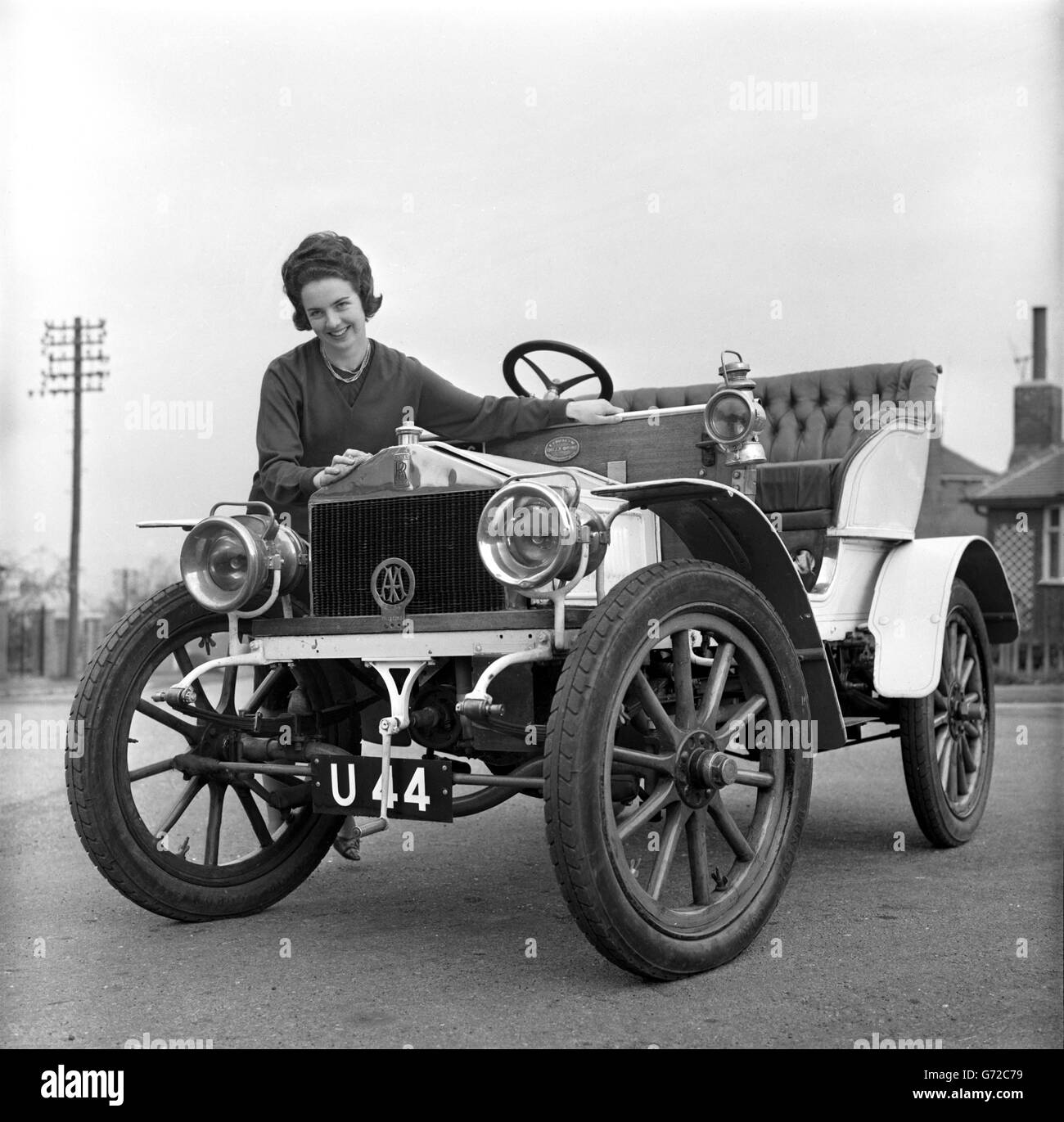 Judy Langton, 19-year-old secretary of Armley, Leeds, with a veteran Rolls-Royce, dating from 1904, which she drives in local rallies. The car, one of the first ever made, is owned by her father, Oliver Langton, 56, a former speedway rider. Judy has been driving the car for two years and last October took part in the London-Brighton veterans' run. Stock Photo