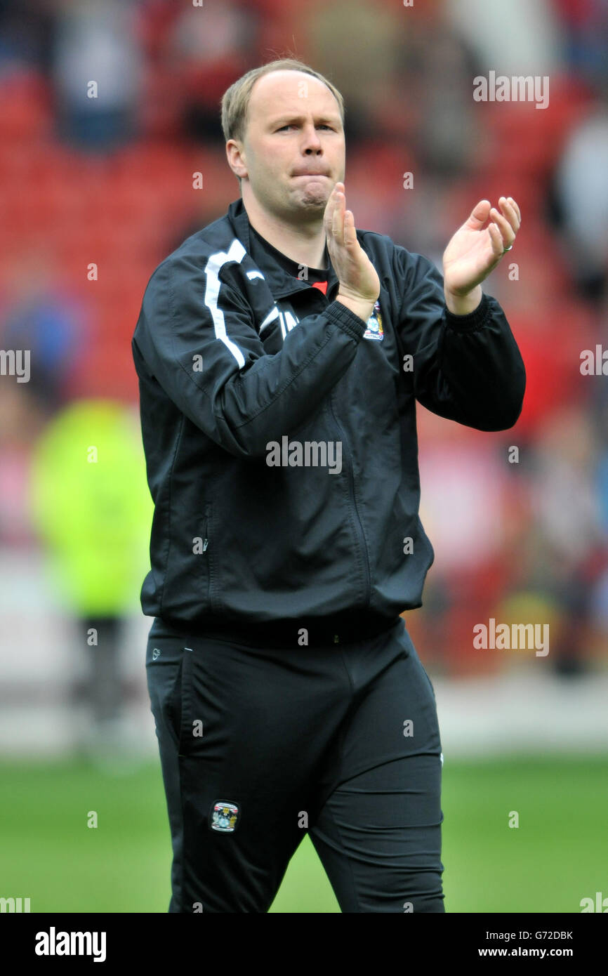 Coventry City's assistant manager Neil McFarland applauds after the game Stock Photo