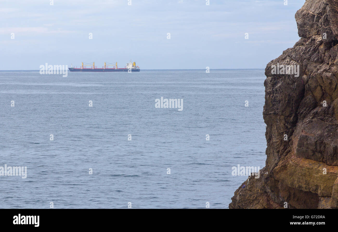 Merchant ship sailing by sea Stock Photo