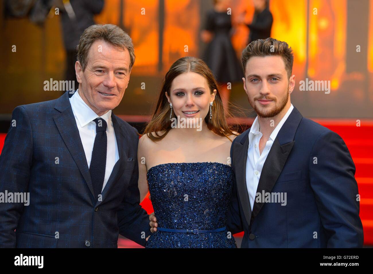Bryan Cranston, Elizabeth Olsen and Aaron Taylor-Johnson arriving at the European premiere of Godzilla, at the Odeon Leicester Square, central London. Stock Photo