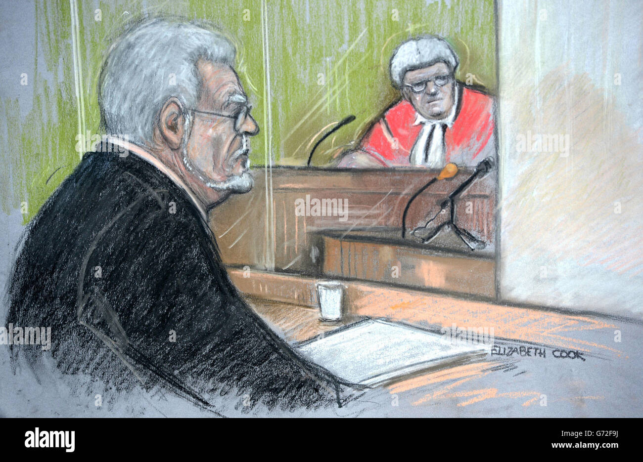 Court artist sketch by Elizabeth Cook of Rolf Harris in the dock at Southwark Crown Court, London as a witness gives evidence behind a curtain watched by the judge, Mr Justice Sweeney. Stock Photo